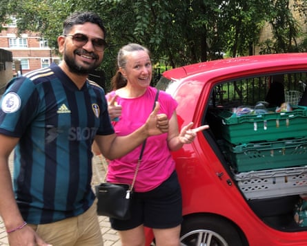 Vimal Pandya and another volunteer use a car owned by a volunteer to deliver food in south London.