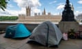 People rough sleeping in tents next to the River Thames opposite the Palace of Westminster