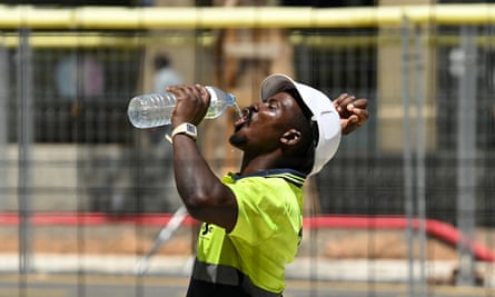 A construction worker cools off by drinking a bottle of water in Barcelona during the extreme heat.