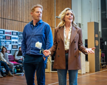 She holds a white carnation in a rehearsal room