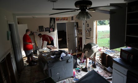Men removing ruined items from a home following flooding in the wake of Hurricane Harvey in Dickinson, Texas.