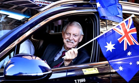 A veteran waves the Australian flag during the parade.