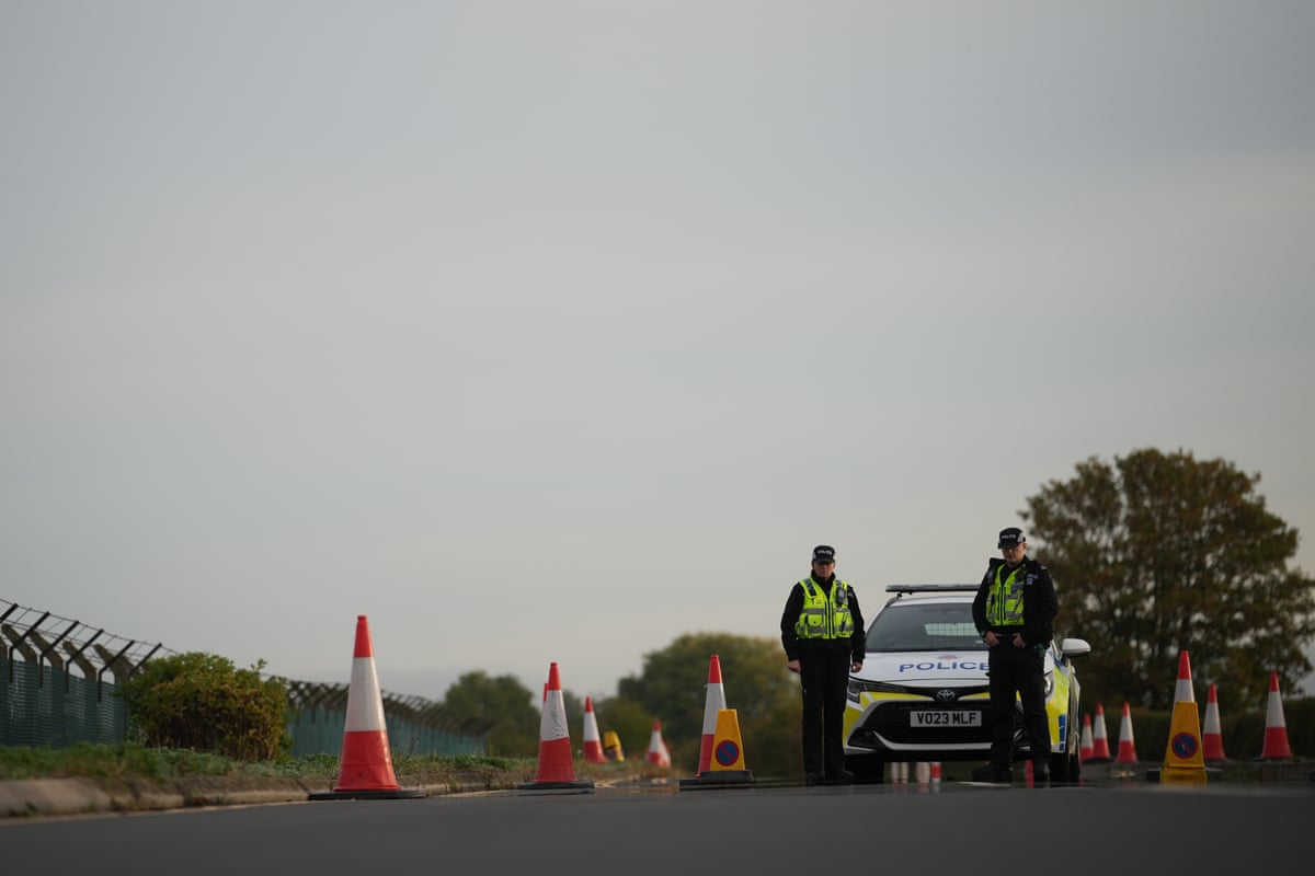 Police officers guard a road leading to RAF Fairford.