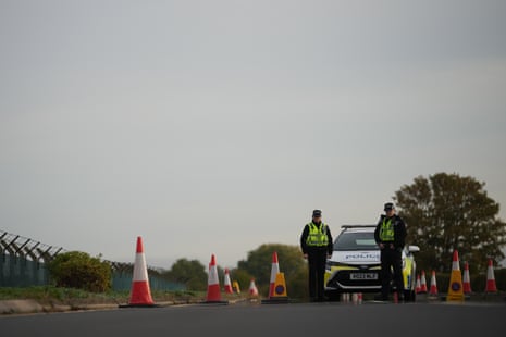 Police officers guard a road leading to RAF Fairford.