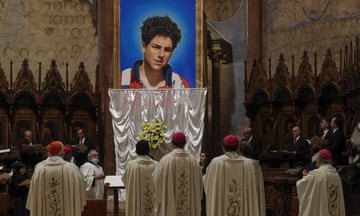 Catholic clerics gathered before an image of Carlo Acutis in a basilica