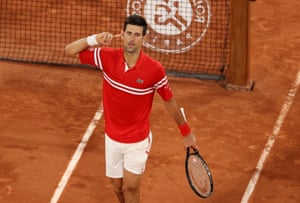 Novak Djokovic gestures to the crowd as he celebrates winning the third set.