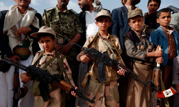 Yemeni children carrying weapons take part in a gathering organised by Shiite Huthi rebels to mobilise more fighters to fight pro-government forces, on 18 June 2017 in the capital Sana’a. 