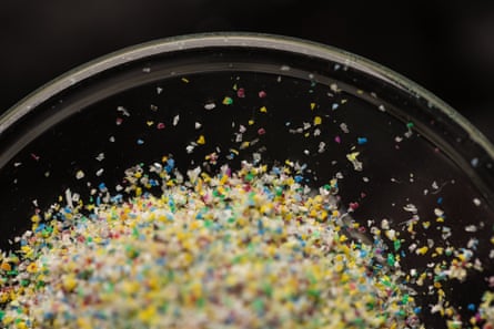 Closeup of clear dish of pile of tiny brightly colored bits of plastic.