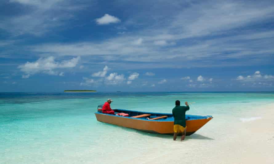 Two Tuvaluan fishers land on Tepuka island, Tuvalu.