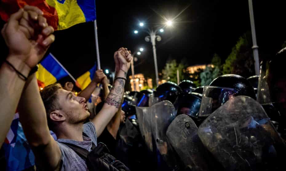 Protesters demonstrate in front of the Romanian government headquarters in Bucharest on 10 August.
