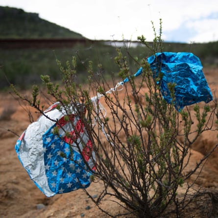An American flag balloon rests in a bush near the border in Tecate, California