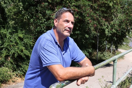Steve Barker leaning on a railing next to a path