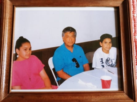 A girl and a boy sit next to an older man.