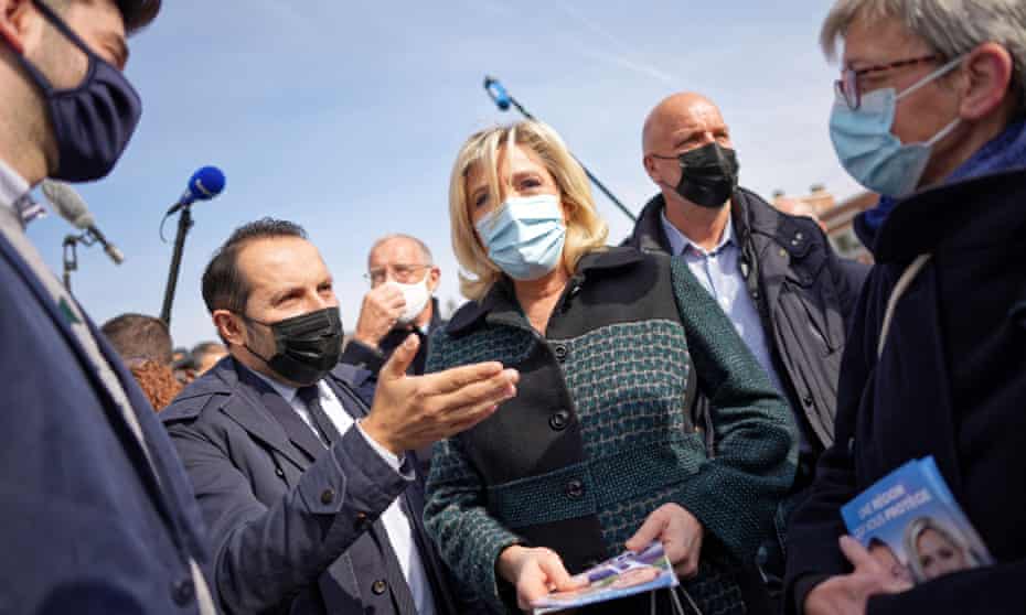 Marine Le Pen, surrounded by campaigners
