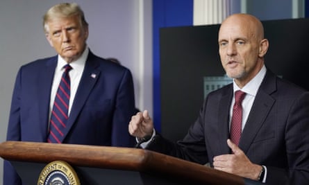 Trump listens as FDA commissioner Stephen Hahn speaks.
