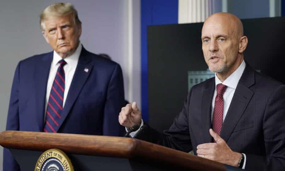 Donald Trump listens as Stephen Hahn, commissioner of the US Food and Drug Administration, speaks during a media briefing on 23 August.