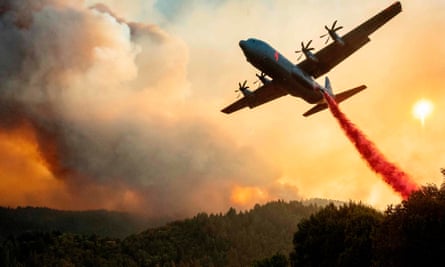 An aircraft drops fire retardant on a ridge during the LNU Lightning Complex fire in Healdsburg, California.
