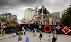 Pedestrians walk past the remains of the Christchurch Cathedral