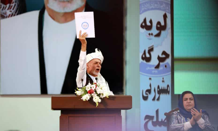 The Afghan president, Ashraf Ghani, shows the final draft of the Loya Jirga’s decision on the release.