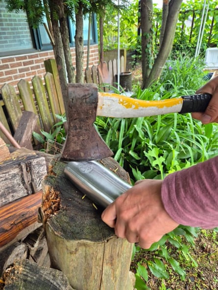 Man holds axe over Starbucks tumbler