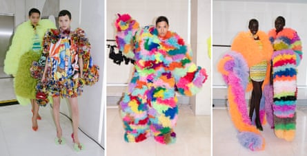 Models posing backstage in elaborate smocked dresses made by hand.
