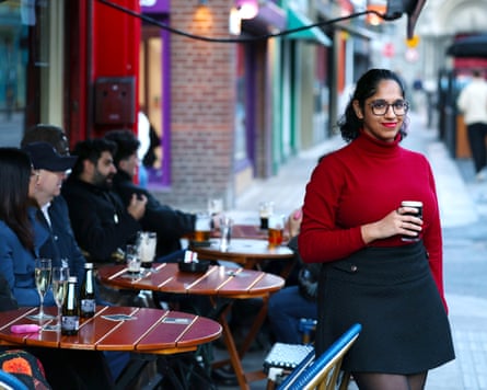 Jaishree Malik holds a pint of stout outside a Dublin pavement café