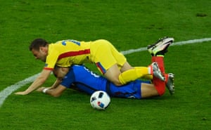 Dimitri Payet is floored by Adrian Popa.