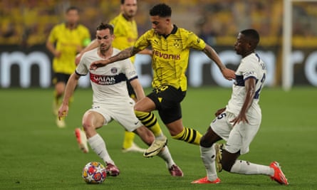 Jadon Sancho glides between PSG’s Fabián Ruiz (left) and Nuno Mendes during Borussia Dortmund’s Champions League semi-final first leg victory.