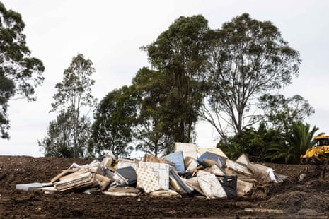 Trucks unload rubbish and debris from the Taree floods at a temporary tip on Kanangra Drive, north of the town.