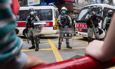 Riot police stand on guard in the middle of the Causeway Bay area during the the protest