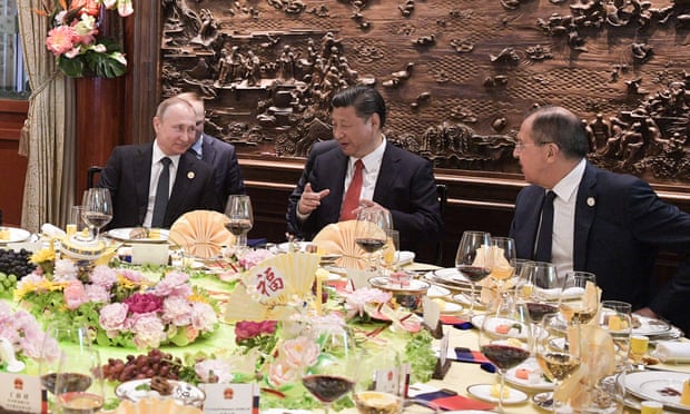 Russian president Vladimir Putin, China’s Xi Jinping and Russian foreign minister Sergei Lavrov enjoy a business breakfast at the summit on Sunday.