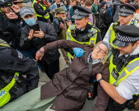 A protester is carried away by police in London’s Trafalgar Square