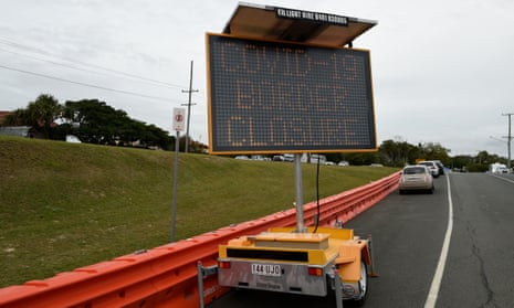 A roadside coronavirus sign and barricades at Coolangatta on the Queensland-NSW border