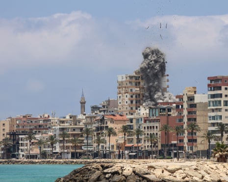 Smoke rises after an airstrike which appears to have hit an apartment block in a dense urban development along the coastal corniche.