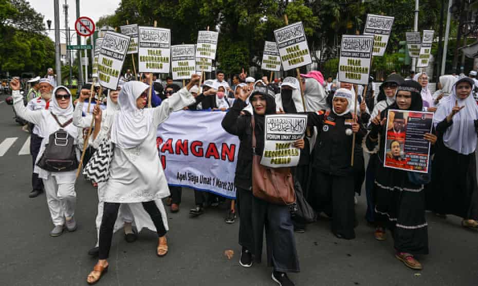 Women participate in a rally calling for clean elections in Indonesia.