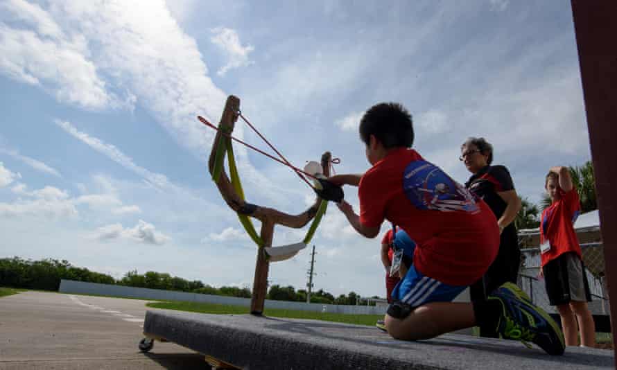A camper does the slingshot to Mars activity during Camp KSC.