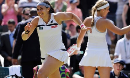 Marion Bartoli runs off court to go to her friends and family after winning the singles final at Wimbledon in 2013.