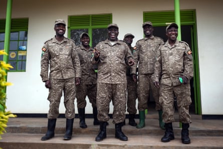 A group of men wearing camouflage outdoors clothing on the veranda of a building
