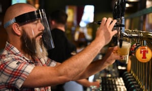A bartender pours beer at The Kitchen Bar in Belfast, Northern Ireland.