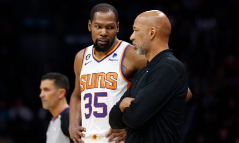 Monty Williams, right, speaks with Kevin Durant during a March game.