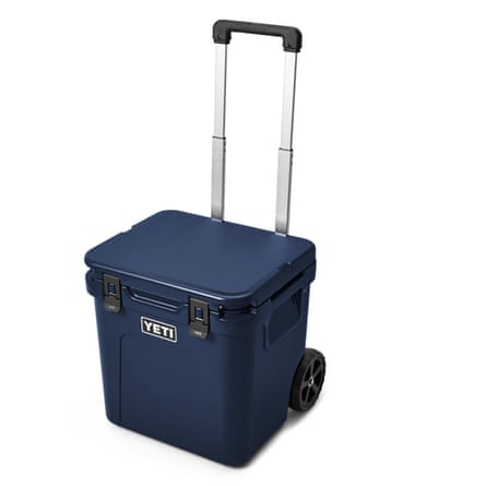 A navy blue Yeti Roadie 48 Wheeled Cool Box with a retractable handle.