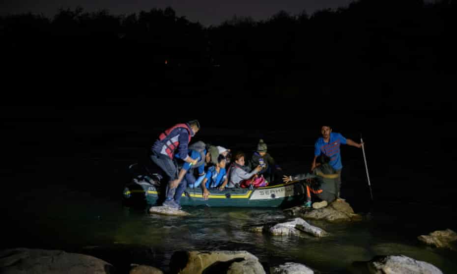 Oscar, an unaccompanied Guatemalan child migrant, crosses the Rio Grande river from Mexico on an inflatable boat, before turning himself over to US border patrol agents.