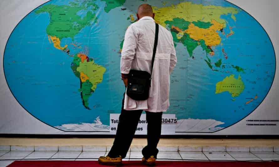 A Cuban doctor contemplates a map of the world