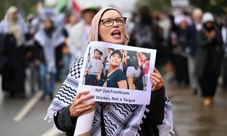 A person holding a placard picturing Australian aid worker Zomi Frankcom, who was among a group of aid workers killed by an Israeli air strike while they were delivering food in Gaza. 
