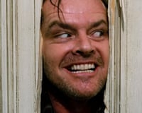 Jack Nicholson grins manically through a hole he hacked in a wooden door
