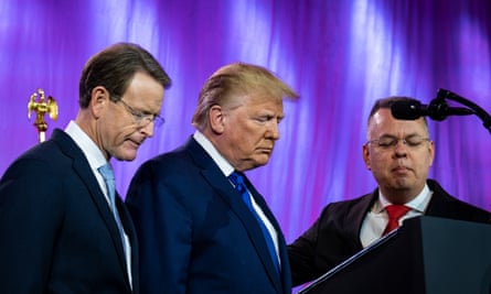 Trump prays between Tony Perkins, the president of the Family Research Council, and Pastor Andrew Brunson, at the council’s annual gala in Washington in October.