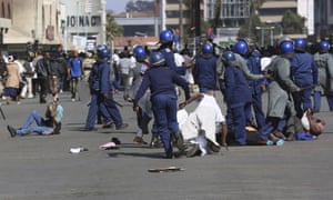 Riot police forcibly apprehend people during protests in Harare on Friday.