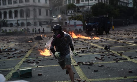 A protester throws a molotov cocktail at police in Hong Kong in November 2019