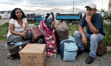 Venessa Márquez and Jesús Andrade sit with their possessions just after crossing the Venezuelan border into Brazil.