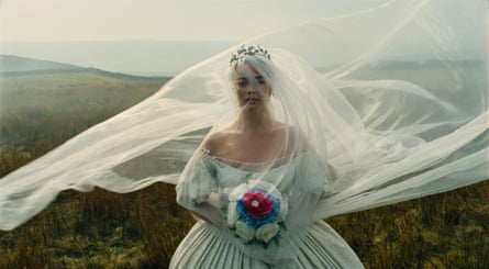Film still of Margot Robbie in wedding dress in the moors